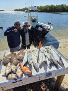 Clients with their catch on a private Tampa fishing charter